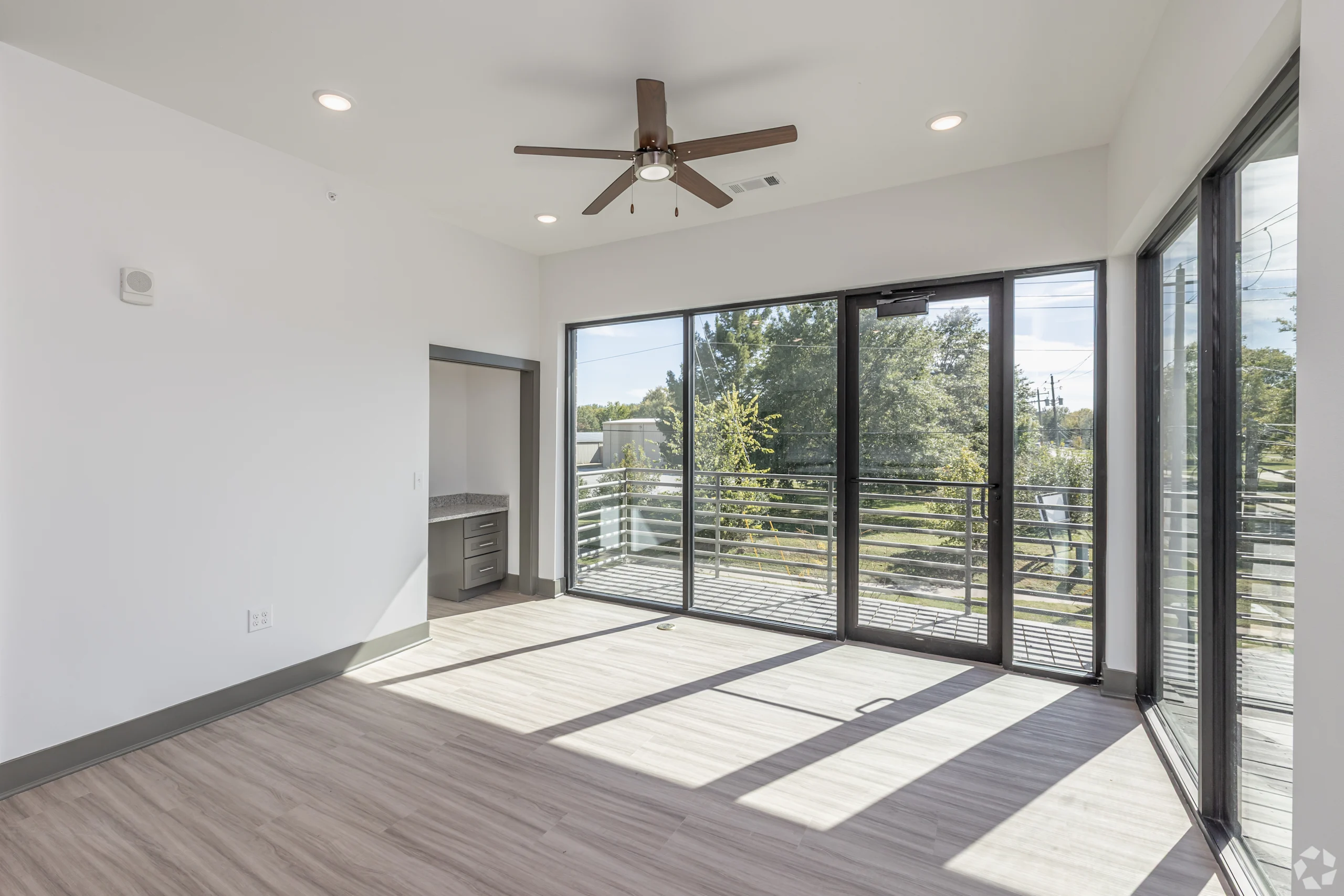 Corner living room with floor-to-ceiling windows and private balcony access